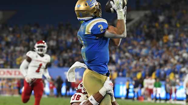 Sep 18, 2021; Pasadena, California, USA; UCLA Bruins wide receiver Kyle Philips (2) makes a catch for a touchdown against Fresno State Bulldogs defensive back Bralyn Lux (38) in the fourth quarter at Rose Bowl. Mandatory Credit: Richard Mackson-USA TODAY Sports